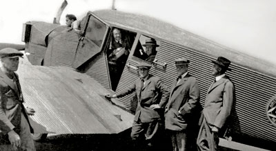 DeMille and his partners with a Junkers-Larsen, one of the Mercury Aviation planes.